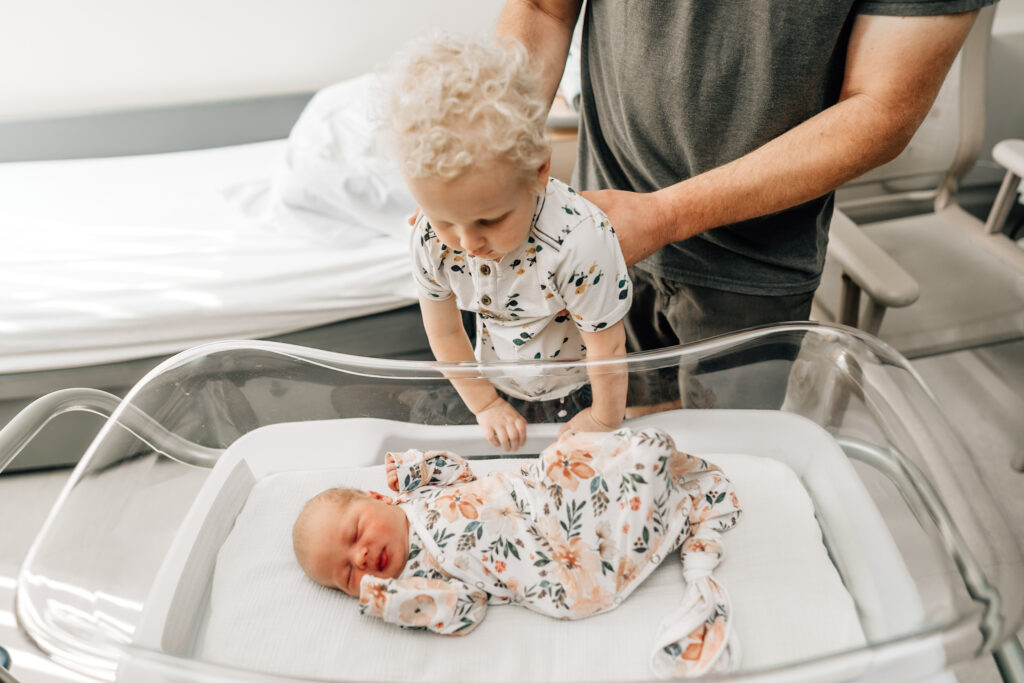 mother with her son welcoming a new baby into the world in a hospital setting by Vanessa Montano Photography - Bay Area Labor and Delivery Photographer