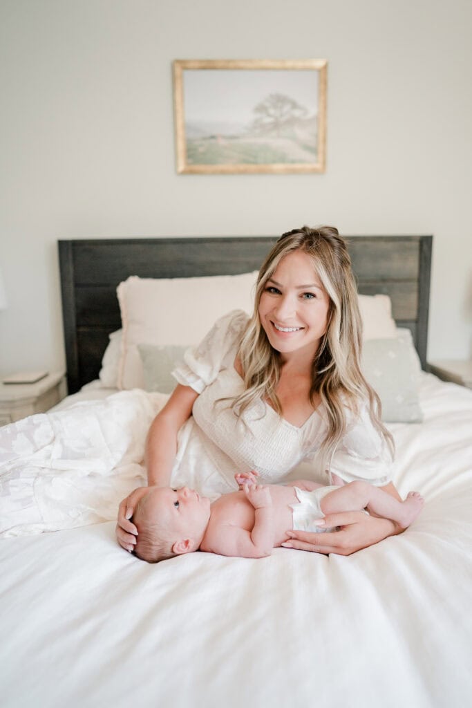 mother on bed with her newborn baby