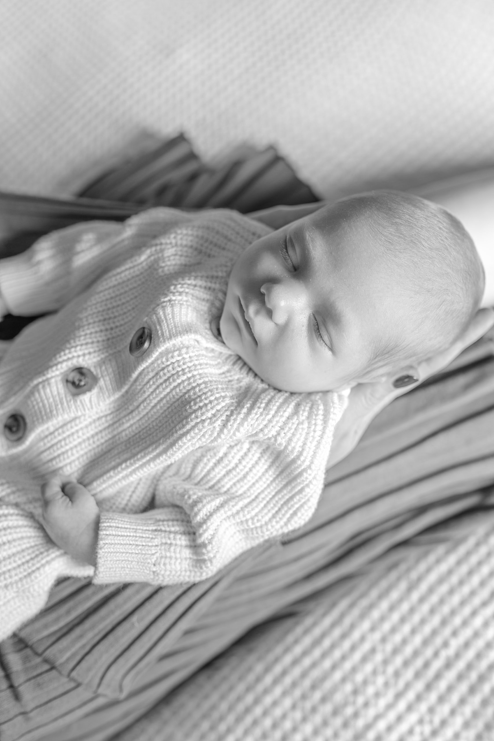 In-home newborn photography in Pleasanton CA with parents holding baby