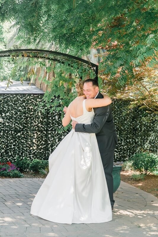 Wedding couple embracing at rustic Northern California wedding venue The Old Homestead Crockett CA