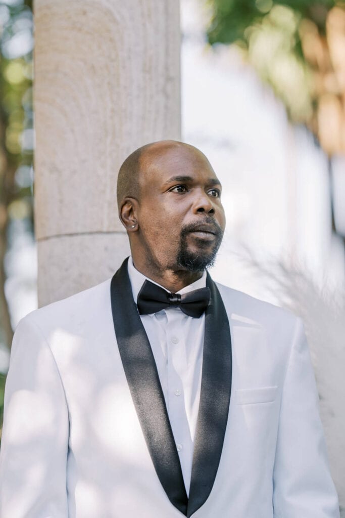 Groom looking at the bride for the first time walking down the isle at Brownstone Gardens image by Vanessa Montano