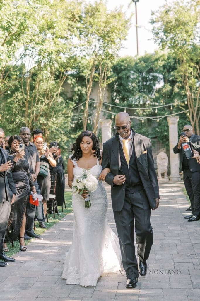 Bride walking down the isle with dad in arm link at Oakley Ca Wedding