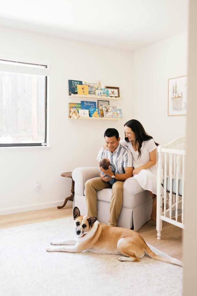 Family coordinating soft, neutral outfit tones for a photoshoot that includes their dog