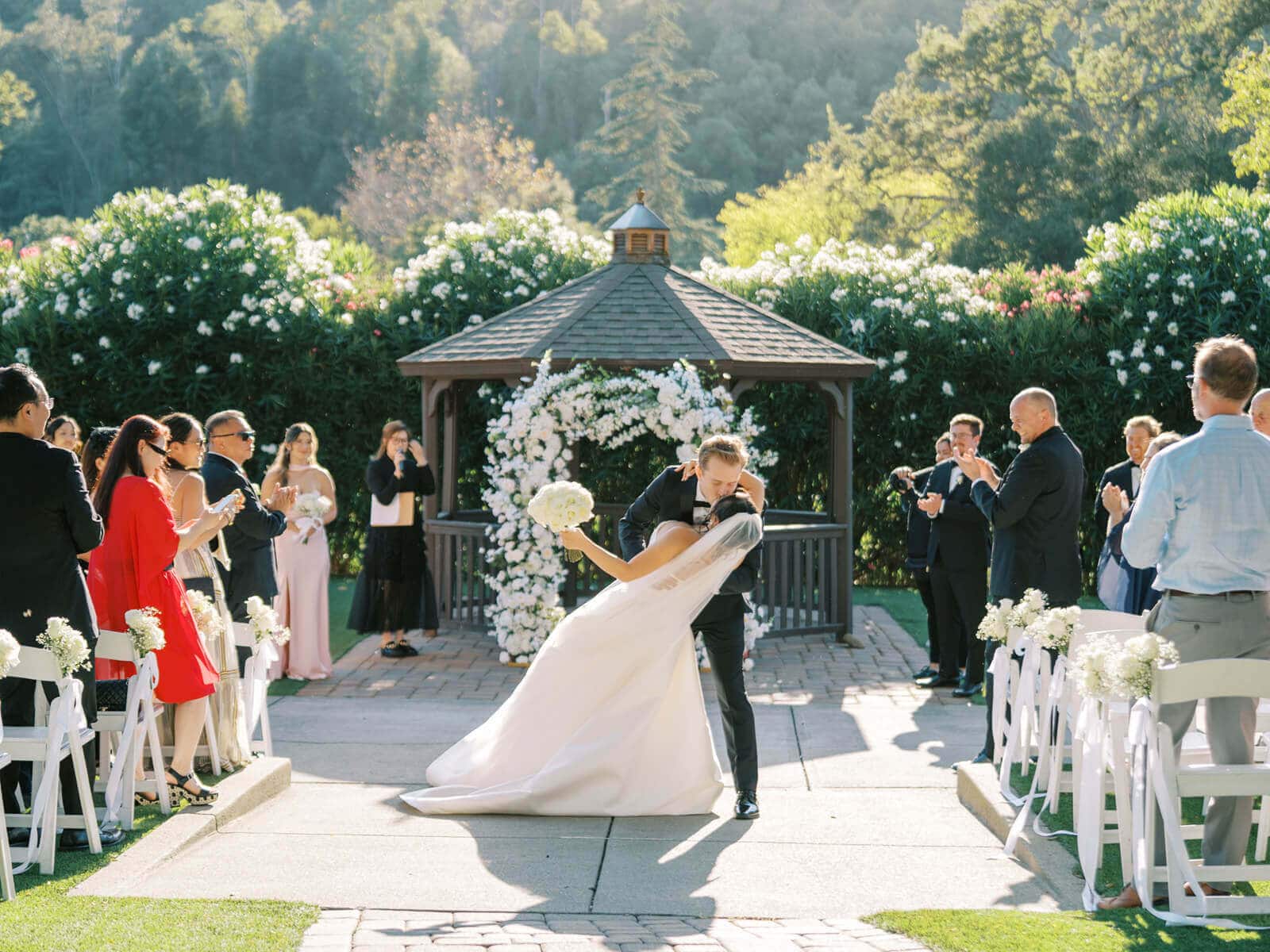 Vivian and Brady celebrate after their outdoor wedding ceremony at Elliston Vineyards in Sunol, California.