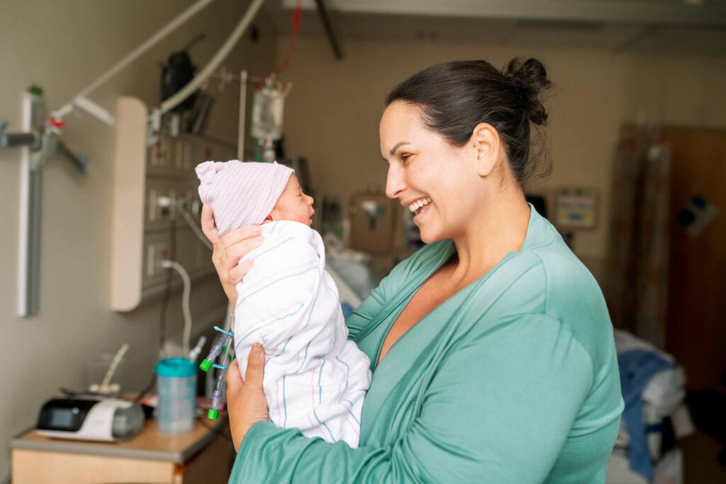 Mother and newborn sharing a quiet moment during a Bay Area hospital newborn photography session