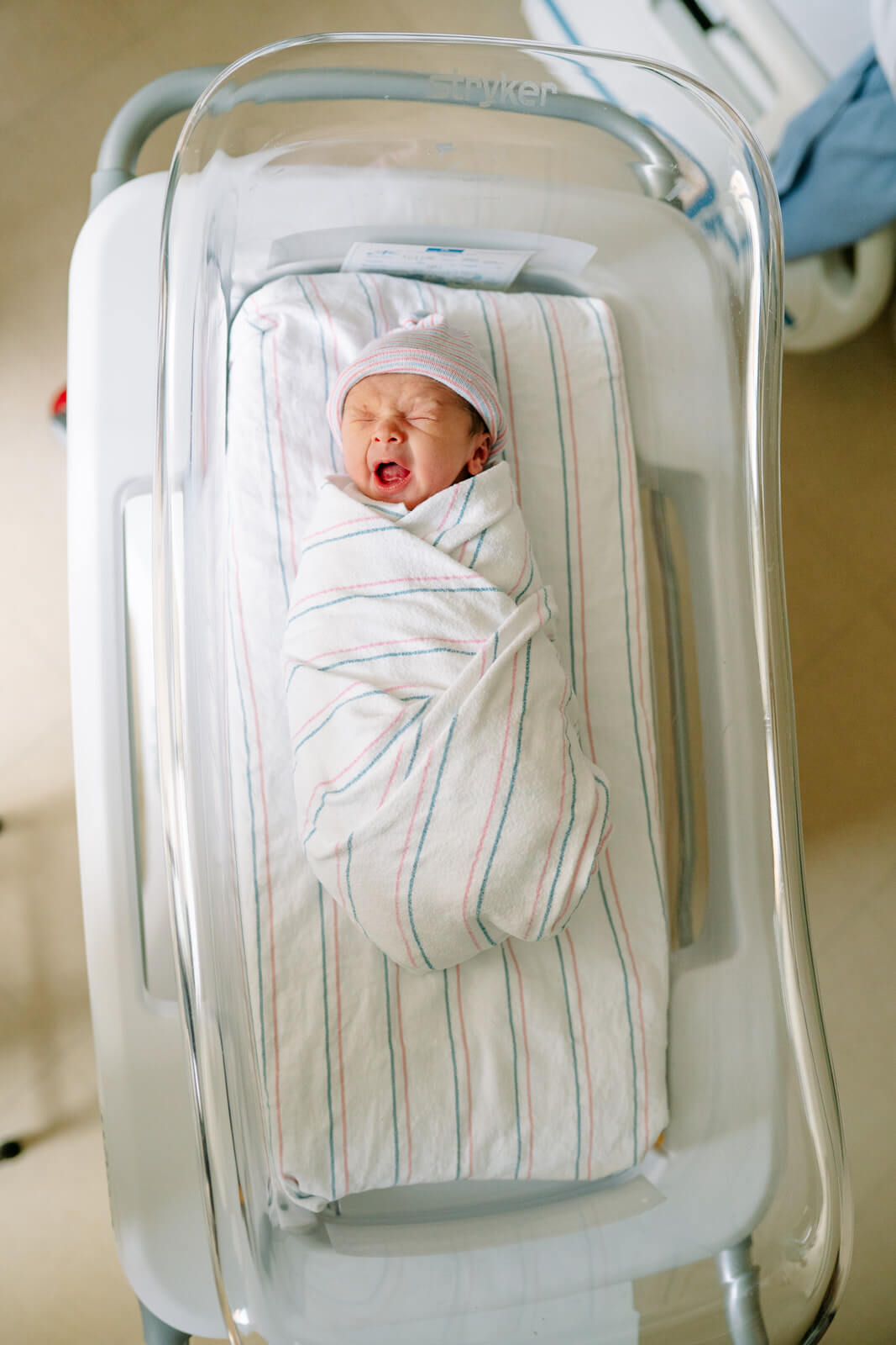 Newborn baby resting in hospital bassinet during a Fresh 48 session in the East Bay